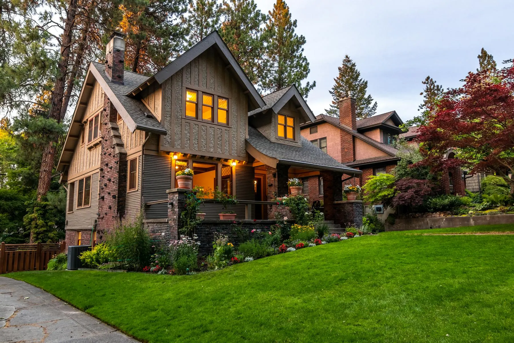 Pacific Northwest craftsman home with cedar siding, pitched gables, and lush landscaping